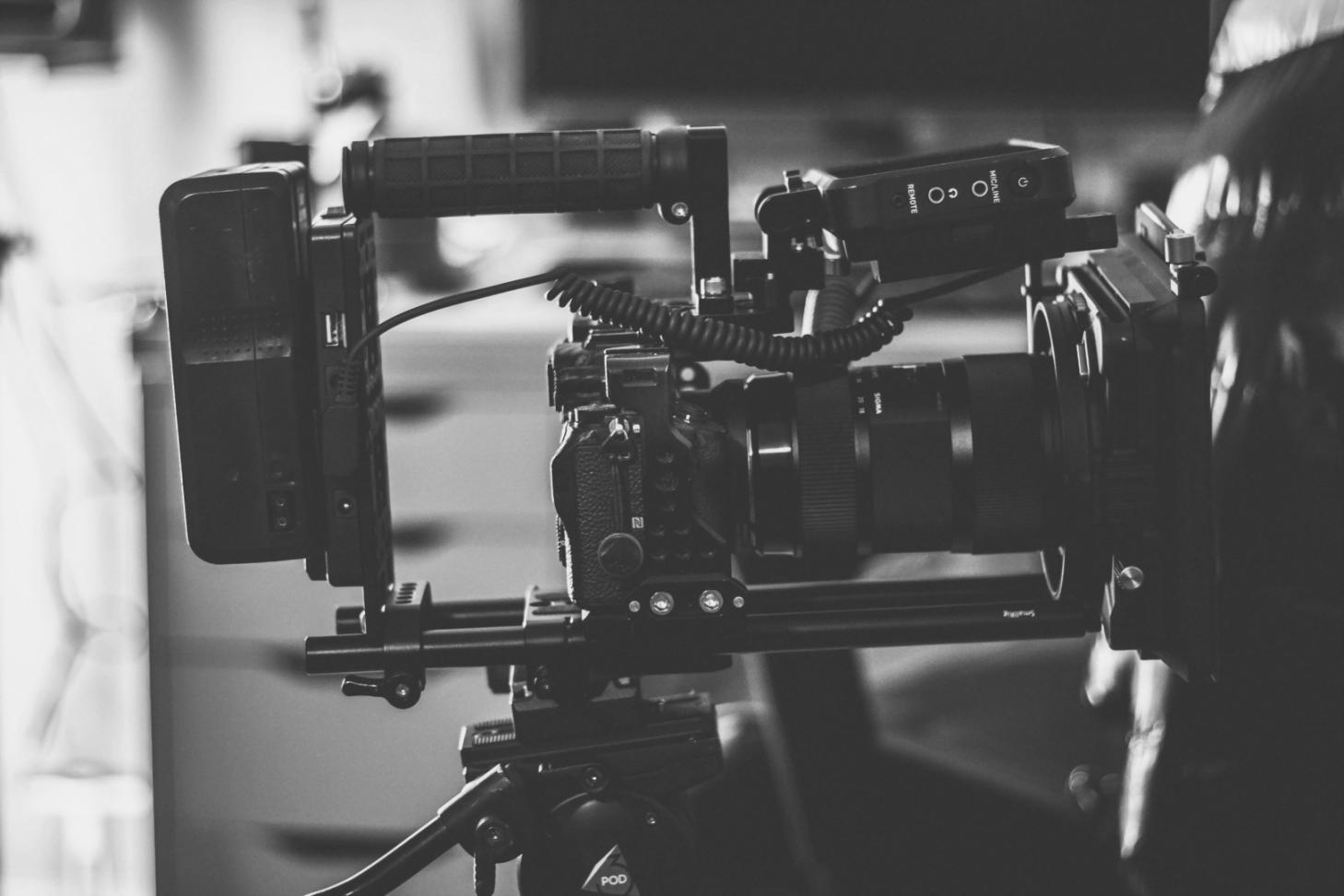 Professional color grading suite with multiple monitors displaying video footage