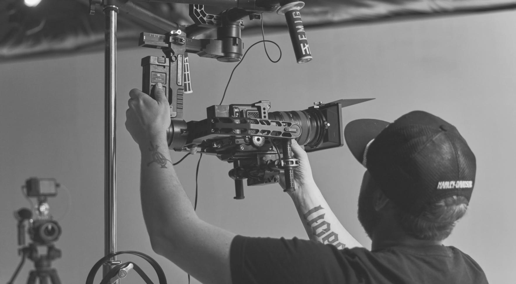 Professional color grading workspace with high-end monitors displaying color correction software